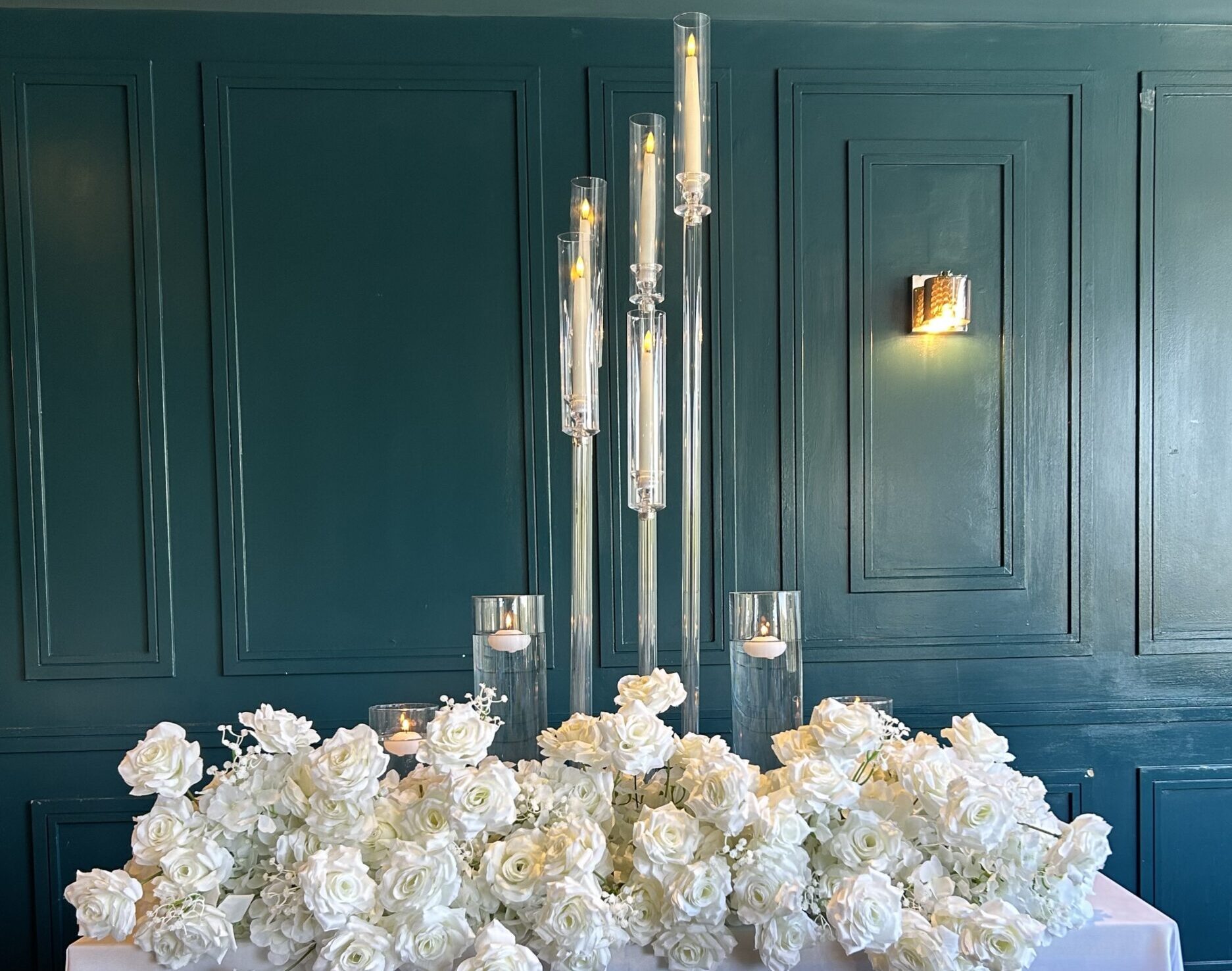Couples table table with white roses and a 5 arm candelabara